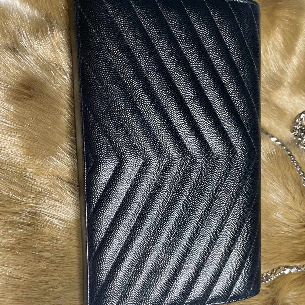 Ysl wallet on chain . Black and silverware